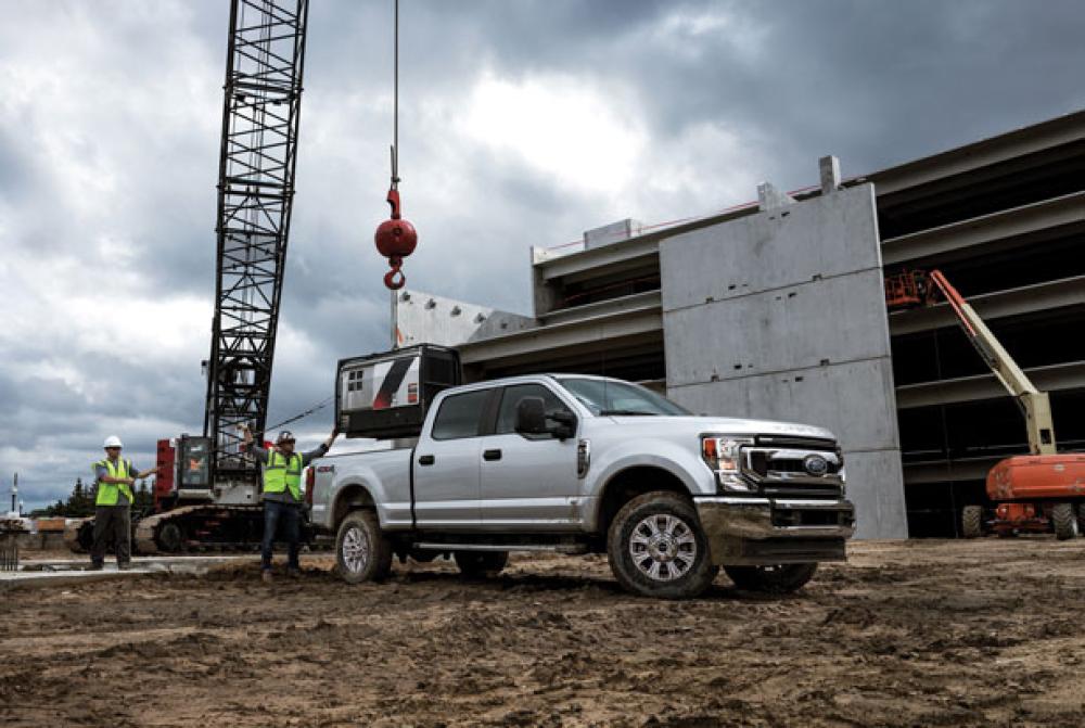 A Ford Super Duty truck in a construction site with a crane