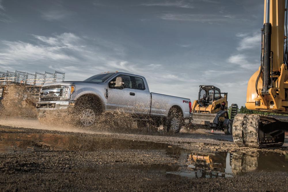 A Ford Super Duty truck in a construction site with tractors