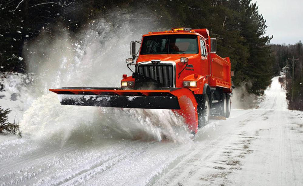 A Western Star truck snow plowing a road